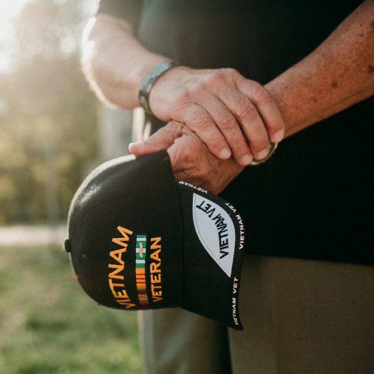 Hands holding a Vietnam veteran hat